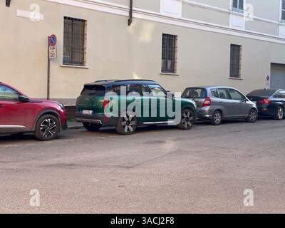 Crema, Italien - 2. März 2025 Parkwagen entlang der Straße im Stadtzentrum sind mit einem British Racing Green Mini Countryman Cooper SE, einem grauen Honda Jazz, A ausgestattet Stockfoto