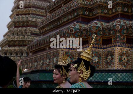 Zwei Frauen in traditioneller thailändischer Kleidung besuchen den Wat Pho Tempel Stockfoto