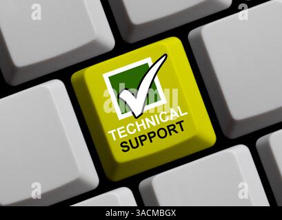 Gelbe Computertastatur mit Häkchen zeigt technischen Support an Stockfoto