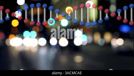 Bild eines dna-Strangs, der sich über die Lichter und die Stadtlandschaft dreht Stockfoto