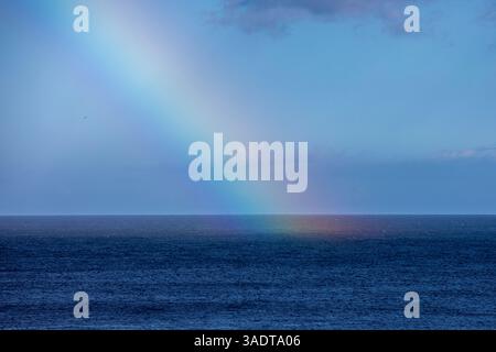 Regenbogen über dem Meer bei stürmischem Wetter, natürlicher Hintergrund. Stockfoto