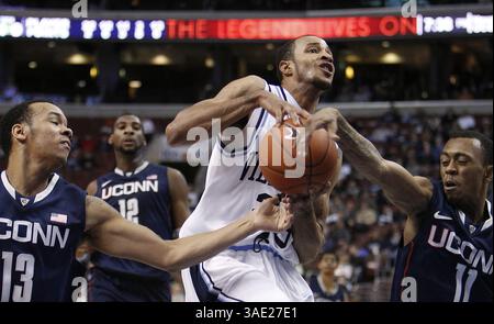 20. Februar 2012 - Philadelphia, PA, USA - Villanovas Dominic Cheek punktet trotz der Verteidigung von Connecticuts Shabazz Napier (13) und Ryan Boatright, rechts, während der ersten Halbzeit im Wells Fargo Center in Philadelphia, Pennsylvania, Montag, 20. Februar 2012. (Bild: © Ron Cortes/Philadelphia Inquirer/MCT/ZUMAPRESS.com) Stockfoto