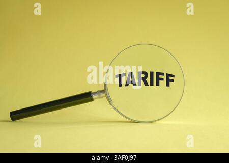 Lupe auf gelbem Hintergrund mit Meldung Tarif. Stockfoto