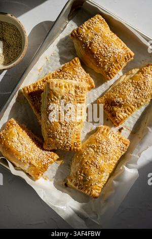 Frisch gebackenes Blättergebäck mit Sesamsamen auf dem Backblech Stockfoto