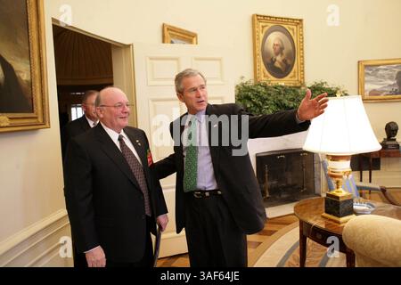 März 2005; Washington, DC, USA; Präsident GEORGE W BUSH spricht mit dem Veteranen der US-Armee Tom Cadmus, dem Nationalen Kommandeur der American Legion, im Oval Office Donnerstag, 17. März 2005. Stockfoto