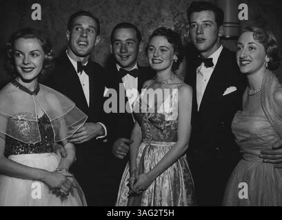 Sydneys liebste Mädchen in glamourösen Kitteln gehörten zu den 800 Gästen, die den Models and Photograers' Ball im Trocadero besuchten. Filmkameras, die die Szene filmen, gaben ihr eine festliche Atmosphäre. Das Besondere des Balls war die Mitternachtsparade von zwanzig führenden Fotomodellen, als das Top Model von 1952 ausgewählt wurde. Die Petite Brünette Valerie May erhielt die Trophäe, die jährlich eine silberne Stativkamera auszeichnen wird. Die Erlöse waren für die Familie Smith. Die Modelle Michelle Safarg (links), Loretta North und Louise Mitchell mit den Partnern Geoff Fraser, Vince Moran und Peter Hanlon. Juli Stockfoto