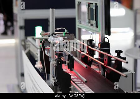 Prüfung des automatischen Codelesesystems an der Förderlinie Bildverarbeitung mit maschineller Bildverarbeitung. Selektiver Fokus. Stockfoto