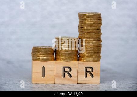Internal rates of return text on wooden cubes with stacking golden coins. IRR and investment concept. Stockfoto