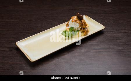 Dessert mit Blätterteig und Eis mit Karamell auf einem Teller Stockfoto