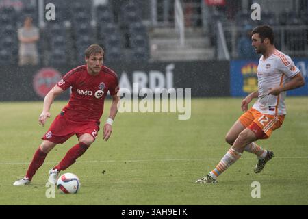Luke Moore (27) dribbelt am 10. Mai 2015 im BMO Field in Toronto (Kanada) gegen den Houston Dynamo Stürmer will Bruin (12). (Foto: © Cal Sport Media/ZUMAPRESS.com) Stockfoto
