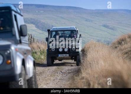 Landrover-Verteidiger fahren einige Rough Green Lanes im Yorkshire Dales National Park bei Hawes, Großbritannien. Stockfoto