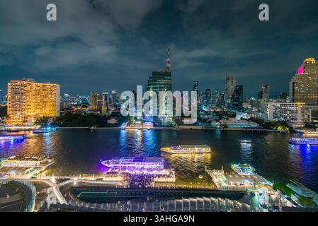 Bangkok, Thailand - 02. Juli: Nächtliche Szene des Flusslebens, beleuchtete Skyline der Stadt und Flussboote, Blick von der obersten Etage, Außenterrasse des Wahrzeichens Stockfoto