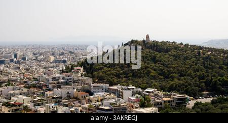 Ein Panoramablick auf die Stadt Athen und das Denkmal von Philopappos auf dem Hügel Filopappou, von der Akropolis aus gesehen. Stockfoto