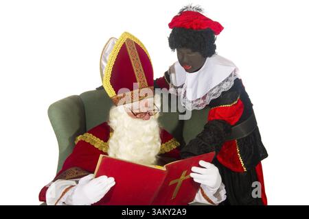Niederländische Kultur mit Sinterklaas und schwarzen Piet und dem großen roten Buch Stockfoto