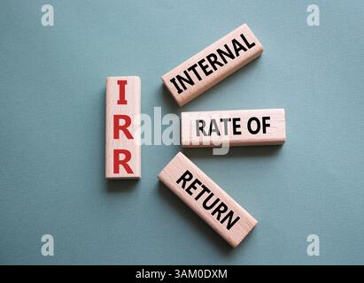 IRR - Internal Rate of Return symbol. Concept word IRR on wooden cubes. Beautiful grey green background. Business and IRR concept. Copy space. Stockfoto