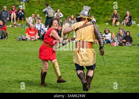 Dorchester, Dorset, Großbritannien. April 2025. Britannia Roman spielt eine Gladiator-Demonstration vor Zuschauern beim Dorchester Roman Festival in Maumbury Rings, Dorchester in Dorset. Die kostenlose Veranstaltung in Maumbury Rings, eine neolithische Henge, die von den Römern um 100 n. Chr. als Amphitheater genutzt wurde, ist Teil einer zweitägigen Veranstaltung, die während der Osterferien an verschiedenen Orten in der Stadt stattfindet. Bildnachweis: Graham Hunt/Alamy Live News Stockfoto