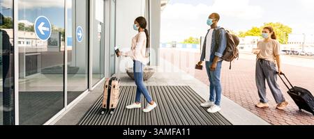 Flughafen Soziale Distanzierung. Passagiere In Masken Stehen In Der Warteschlange, Um Das Terminal Zu Betreten Stockfoto