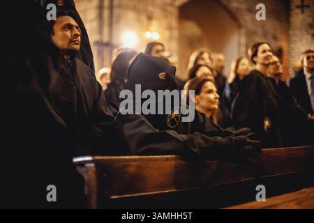 Barcelona, Spanien. April 2025. Kapuzenpönitenten der Bruderschaft Congregacion del Santisimo Cristo de la Buena Muerte bereiten sich auf die Palmensonntagsprozession vor. Credit: Matthias Oesterle/Alamy Live News Stockfoto