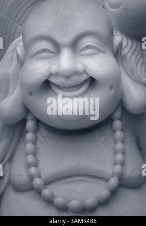 Nahaufnahme Porträt einer lachenden Buddha-Statue Stockfoto