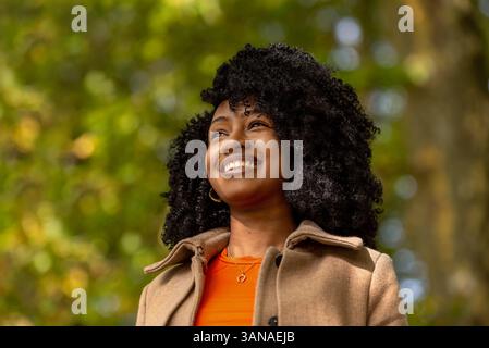 Porträt mit einer schönen jungen Frau, die in einer Herbstkulisse lächelt Stockfoto