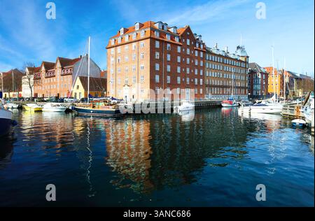 Flusskanal mit vielen Booten und Schiffen mit kleinen alten Häusern in der Nachbarschaft Christianshavn in Kopenhagen, Dänemark Stockfoto