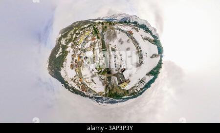 Aus der Vogelperspektive auf eine winzige Planetenlandschaft mit einem ruhigen Dorf umgeben von schneebedeckten Bergen und ruhigen Bäumen, Sorenberg, Luzern, Schweiz. Stockfoto