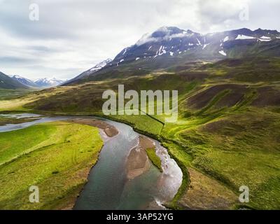 Aus der Vogelperspektive auf Fluss und Grasland vor einem Berg, Oxnadalur, Nord-Island Stockfoto