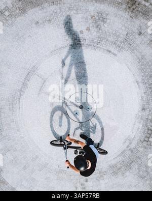 Luftaufnahme des Silhouettenschattens des BMX-Fahrradfahrers auf Betonoberfläche in Panevezys, Litauen. Stockfoto
