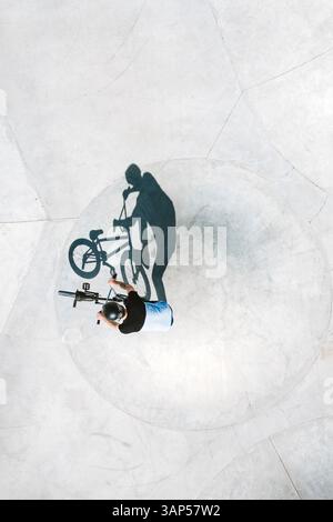 Luftaufnahme des Silhouettenschattens des BMX-Fahrradfahrers im Skate-Pool aus Beton in der Nähe von Panevezys, Litauen. Stockfoto