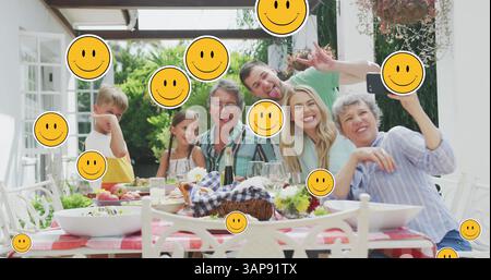 Bild von lächelnden Gesichtern über glückliche kaukasische Familie, die Selfie im Garten macht Stockfoto