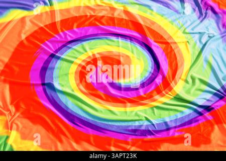 Helles, mit Tie-Dye-Technik gefärbtes Gewebe. Textil mit Wirbeln in Regenbogenfarben Stockfoto