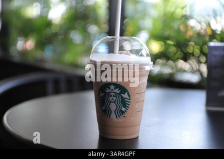 Eine Tasse Starbucks Eisschokolade auf Holztisch. Starbucks ist das größte Kaffeehaus der Welt. Stockfoto