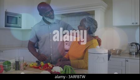 Bild von Lichtflecken über glücklichem afroamerikaner-Paar-Kochen Stockfoto