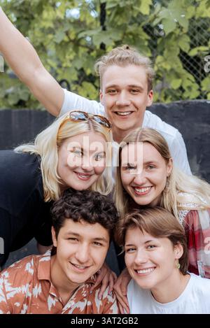 Gruppe fröhlicher Freunde, die im Sommer draußen lächeln Stockfoto