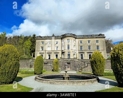 Rydal Hall, ein großartiges historisches Herrenhaus in Ambleside, Cumbria, steht hoch mit formellen Gärten und einem Steinbrunnen. Stockfoto