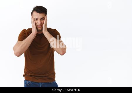 Der Mann, der während der Coronavirus-Pandemie in der Quarantäne zur Selbstisolation geisteskrank wird. Portrait des verdrängten und verspaltenen erwachsenen Kerls spüren Stress und Panik, quetschen c Stockfoto