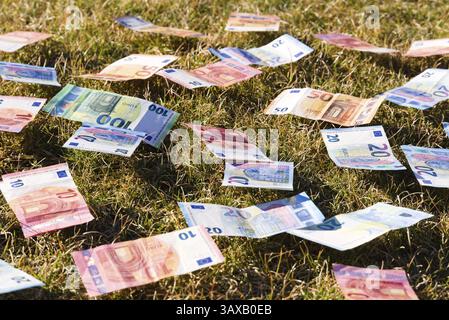 Papiergeld, das lose auf der Wiese verstreut ist - Euro-Banknoten Stockfoto
