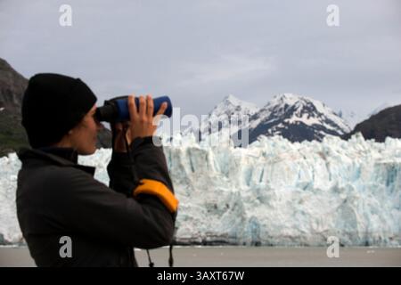 30. Juni 2016 – Juneau, Alaska, USA – Crew mit Fernglas auf dem Schiff Safari Endeavour am Margerie Glacier und Mount Fairweather im Glacier Bay National Park Alaska USA. Tarr Inlet im Glacier Bay National Park. Der Margerie Glacier ist ein 34 km langer Gezeitenwassergletscher in der Glacier Bay in Alaska und ist Teil des Glacier Bay National Park and Preserve. Er beginnt am Südhang des Mount Root an der Grenze zwischen Alaska und Kanada in der Fairweather Range und fließt südöstlich und nordöstlich zum Tarr Inlet. Benannt wurde es nach dem berühmten französischen Geographen und Geologen Emmanuel de Margerie (1862â€“) Stockfoto
