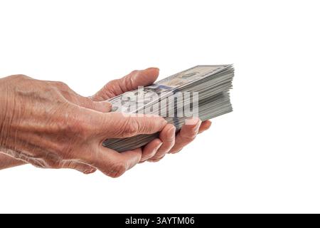 Ein älterer Mensch hält einen dicken Stapel von US-Dollar-Scheinen Stockfoto
