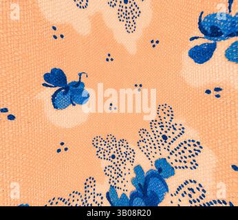 Ein lebendiges Muster mit blauen Schmetterlingen und Blumenelementen vor einem warmen pfirsichfarbenen Hintergrund, das ein lebendiges und verspieltes Design schafft. Ein kreisförmiges Stoffdesign mit einem lebendigen Blumenmuster mit blauen Blumen und zarten Blättern vor einem warmen pfirsichfarbenen Hintergrund. Kleine blaue Akzente und Punkte verleihen der gesamten Ästhetik Tiefe und Charme. Klassische Kunst mit einem modernen Twist von Artotop, transformierte französische Stoffe, erste Hälfte des 19. Jahrhunderts, klassische Kunst mit einem modernen Twist von Artotop Stockfoto