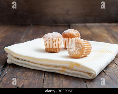 Muffins mit Kaffeetasse auf Holztisch Stockfoto