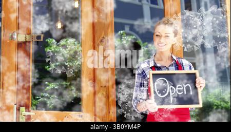 Frau mit roter Schürze, die ein Tafel-Schild am Ladeneingang hält, mit Virengrafiken, Kopierraum Stockfoto