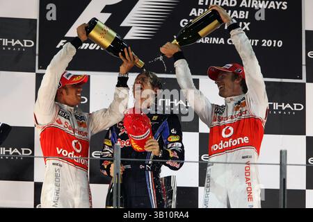 14. November 2010 - Abu Dhabi, Vereinigte Arabische Emirate - Podium (L bis R): Lewis Hamilton (GBR) McLaren, Sebastian Vettel (GER) Red Bull Racing und Jenson Button (GBR) McLaren feiern... Formel-1-Weltmeisterschaft, Rd 19, Abu Dhabi Grand Prix, Race, Yas Marina Circuit. (Vermerk: © Sutton Motorsports/ZUMApress.com) Stockfoto