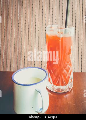 thai Milk Tea serviert mit Eis in einem Glas mit Milch auf der Seite Stockfoto
