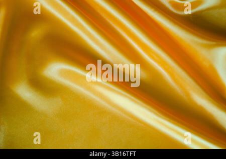 Gelber seidener Glanz, geeignet für Design und Tapetendekoration. Stockfoto