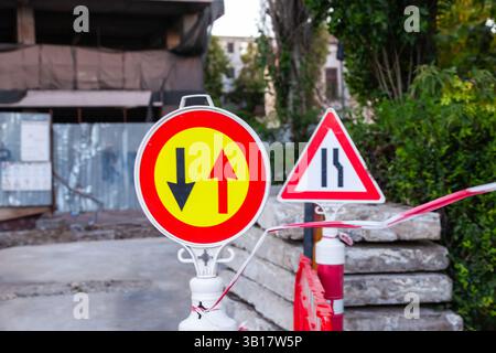 Warnschilder und Kunststoffzäune auf einer Baustelle. Stockfoto