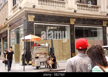 22. August 2009 - New York, New York, USA - Käufer gehen an einem freigewordenen Geschäft auf der Fifth Avenue vorbei. Viele Geschäfte haben aufgrund der schwierigen Wirtschaftslage in New York geschlossen. (Bild: © Nancy Kaszerman/ZUMA Press) Stockfoto