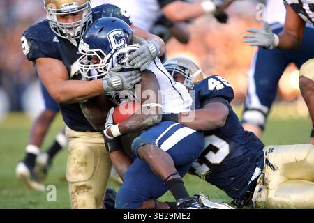21. November 2009: Connecticut Running Back Jordan Todman (23) wird von Notre Dame Defensive Tackle Ethan Johnson (9) und Linebacker Darius Fleming (45) während eines NCAA-Fußballspiels zwischen der University of Connecticut Huskies und der University of Notre Dame Fighting Irish im Notre Dame Stadium in South Bend, Indiana, gewonnen von den Huskies in doppelten Überstunden 33-30. (Credit Image: ZUMApress.com)(Credit: © Dennis Wierzbicki/Media/Media) Stockfoto