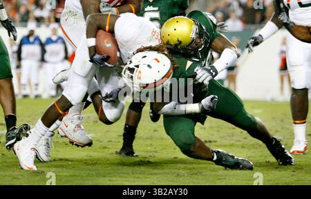 NOVEMBER 2009 - TAMPA, FL, USA - WILLIE J. ALLEN JR. | Times .TP 312214 ALLE BULLS.(11/28/2009 Tampa) Miamis Running Back Graig Cooper (2) wird im dritten Quartal des Spiels von den Bulls Chris Robinson (49) hart getroffen. Finale 31-10 Miami...Beschreibung Spiel der University of Miami Hurricanes und der University of South Florida Bulls Samstag, 28. November 2009 im Raymond James Stadium, Fla. [WILLIE J. ALLEN JR., Times] (Bild: © St. Petersburg Times/ZUMApress.com) Stockfoto