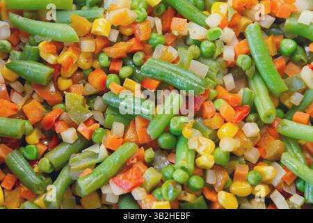 Bunte Gemüsesorten werden in einer Pfanne in Nahaufnahme gebraten. Essen Stockfoto